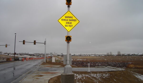 Road Sign That Reads "warning Vehicle Barrier 100 Feet Ahead"